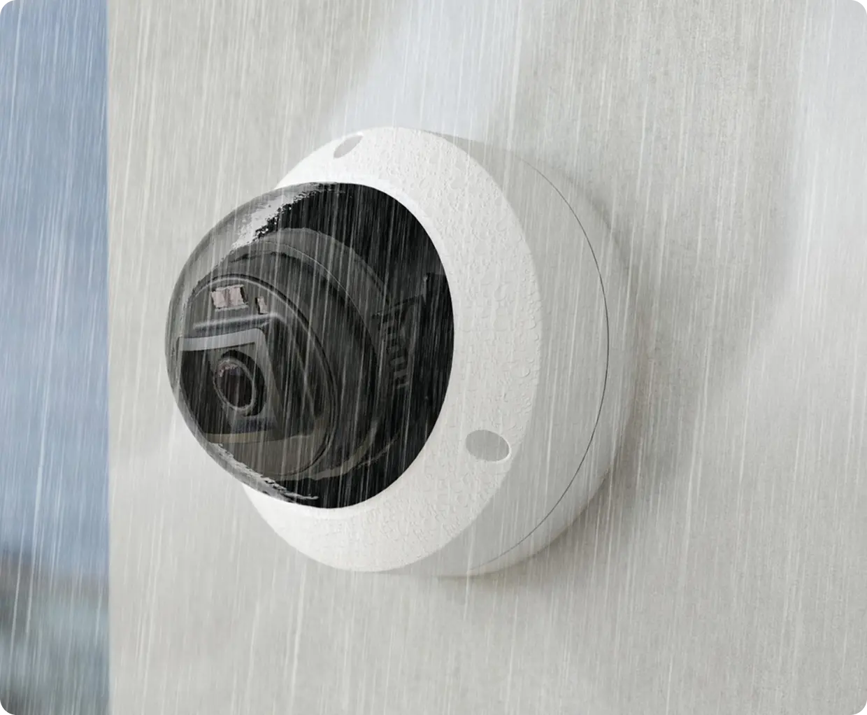 Dome security camera mounted on a wall, monitoring in all weather conditions