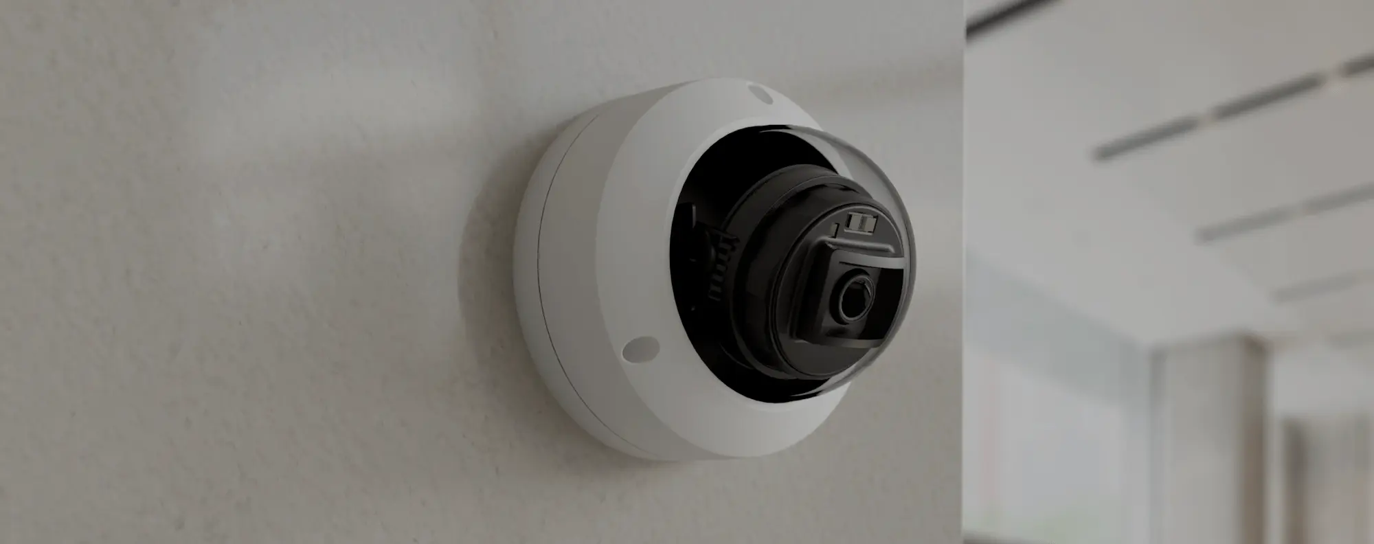 A sleek dome security camera R200 from Rhombus mounted on an indoor wall, showcasing its easy installation and zoom capabilities.