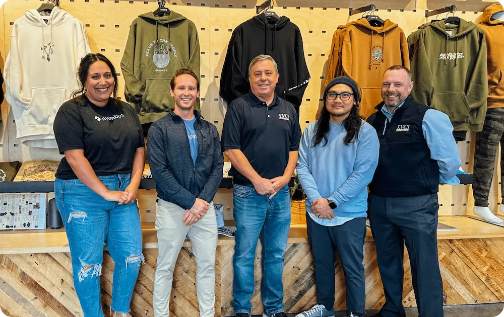 The Rhombus team standing with a customer