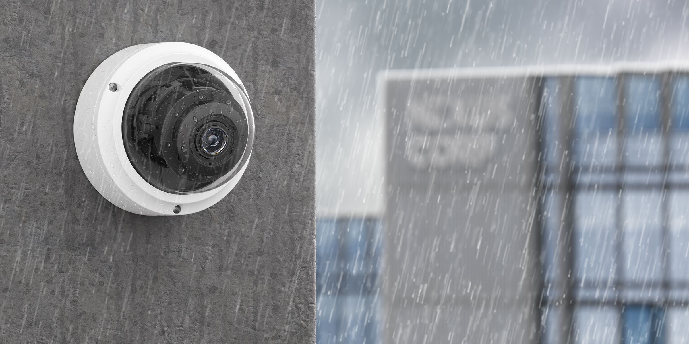 R410 Dome Side Of Building Rain Image of the R410 Dome Camera on wall in outdoor environment in rain.