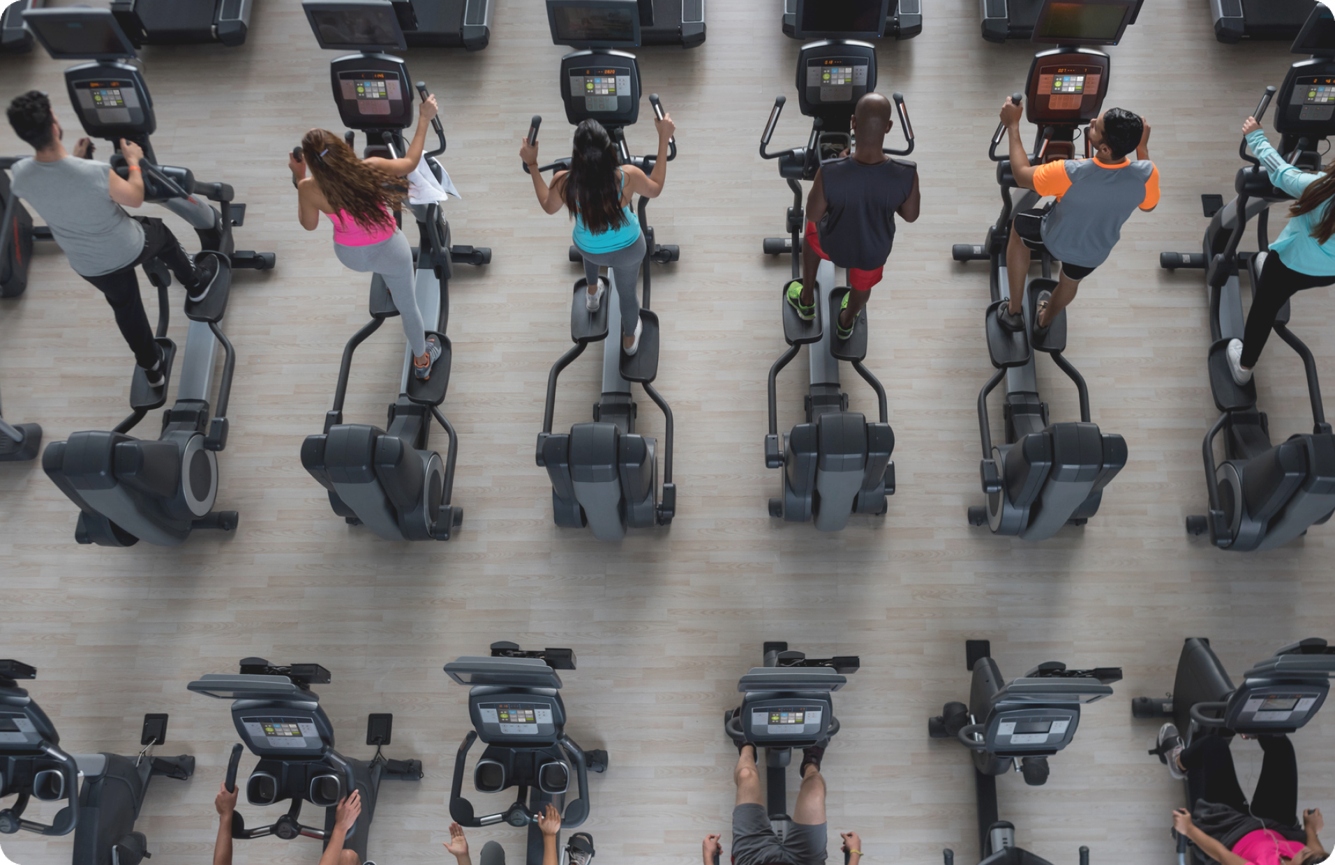 gym go-ers on cardio machines.