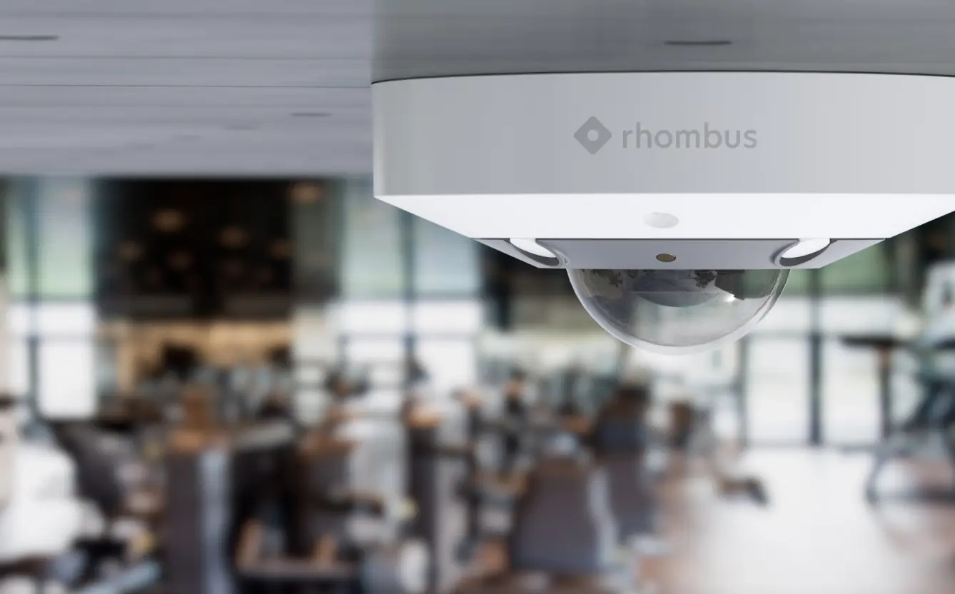 Rhombus R360S fisheye camera installed outdoors, providing panoramic views for wide area surveillance and is NDAA compliant.