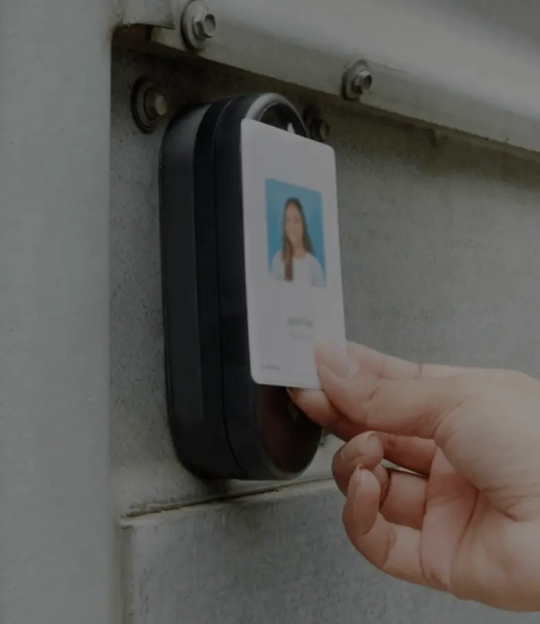 Employee using a Rhombus Secure Card for access control system to tap on a DR20 door reader, demonstrating efficient door access control solutions. This modern door access system ensures secure and convenient entry for authorized personnel. Rhombus access control software seamlessly integrates with door readers, enhancing security and management capabilities.