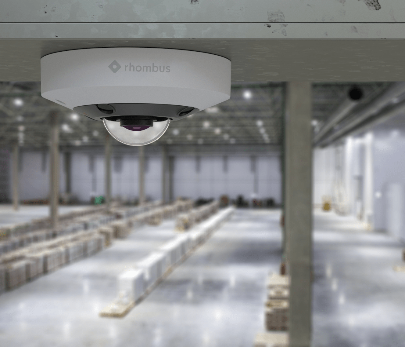 Rhombus fisheye camera installed indoor in a warehouse, offering a fisheye view, NDAA compliance, and compatibility with many IP cameras.